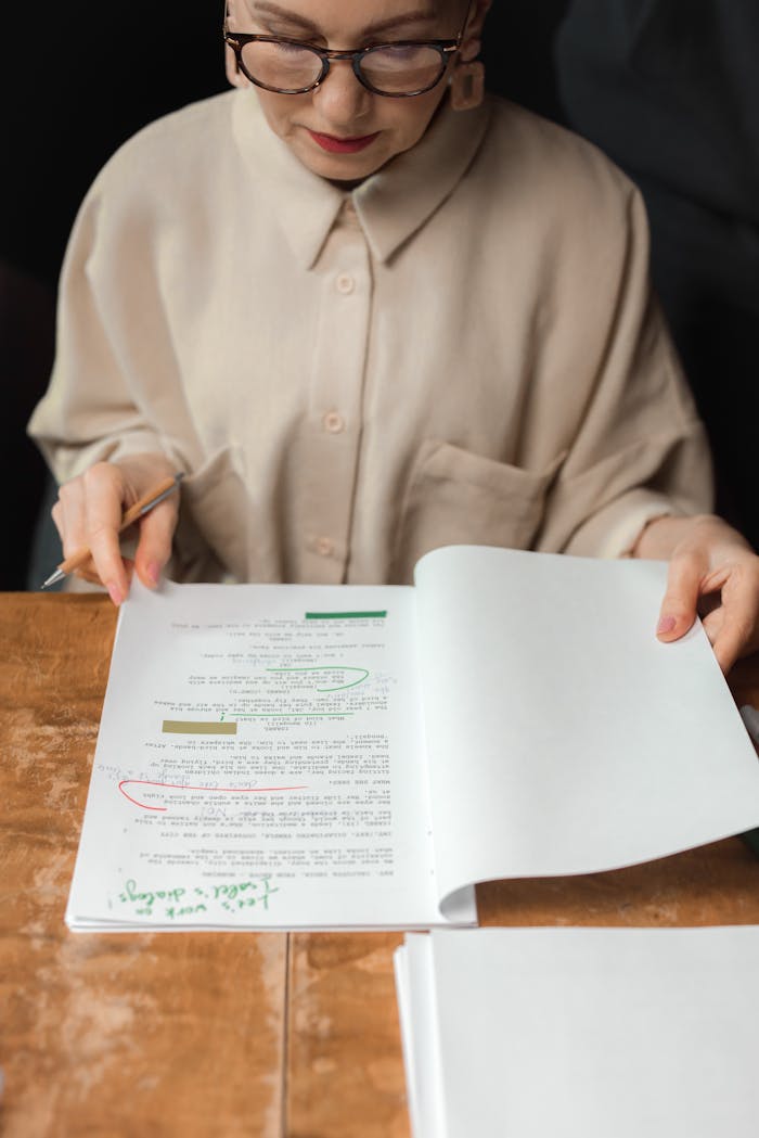 our-services-2 Senior woman reviewing a screenplay script with notes and edits, showcasing expertise.